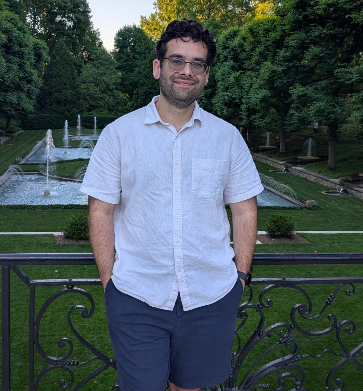 Dane Christensen standing in front of a formal garden with fountains